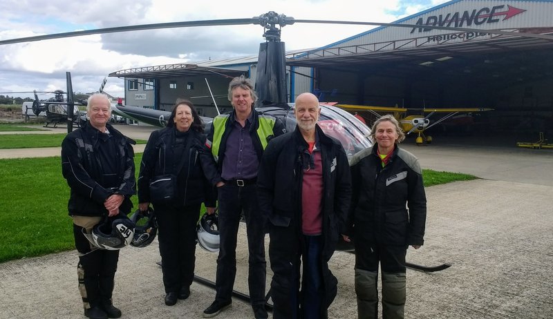 The group standing next to the helicopter that Jeff is learning to fly
