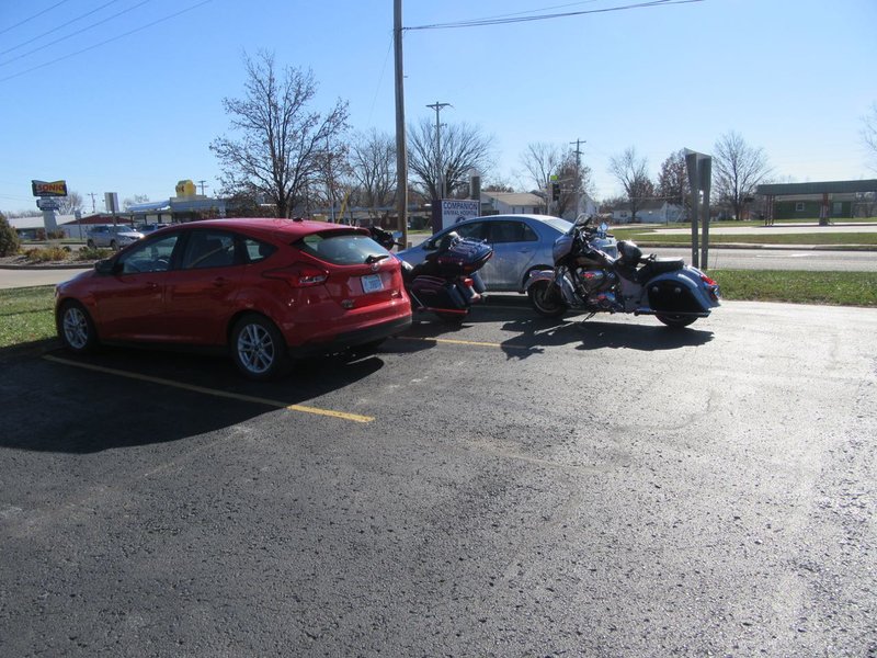 Parking was tight in the lot with all those cars.  Motorcycles had to stack up.