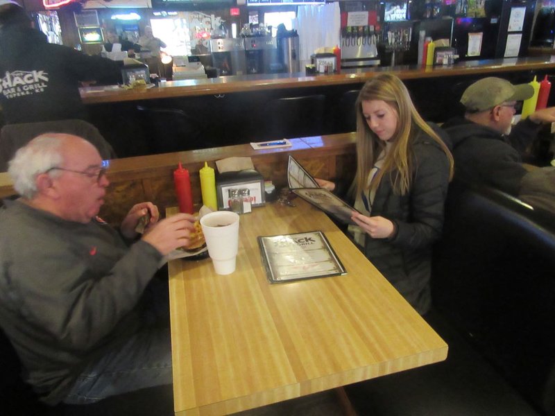 CAROLINE WAS READING THE MENU TO MAKE SURE MARVIN DIDN'T MISS ANYTHING .