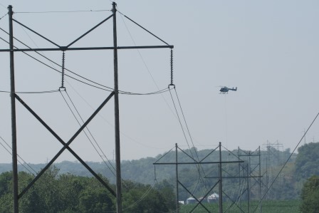 Helicopter supplying high line workers on top the power poles.  North of Leavenworth.