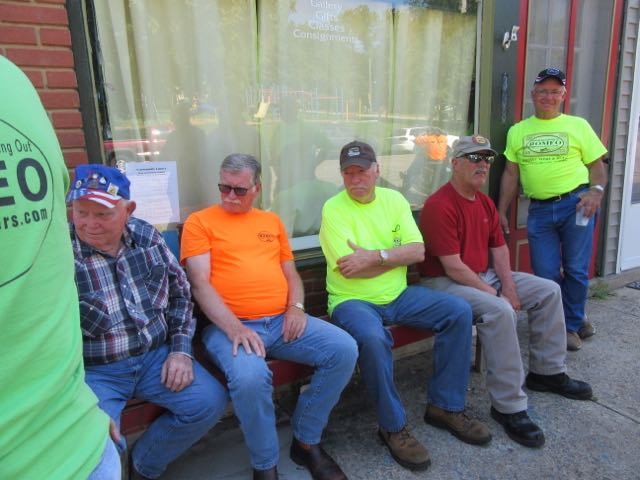 This group was seated in line waiting outside the business featured in the picture below.