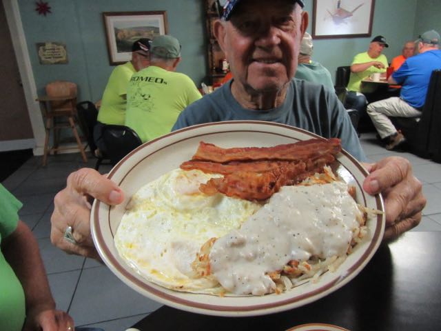 George is pretty excited about this breakfast.  He sure quieted down after they sat that down in front of him.